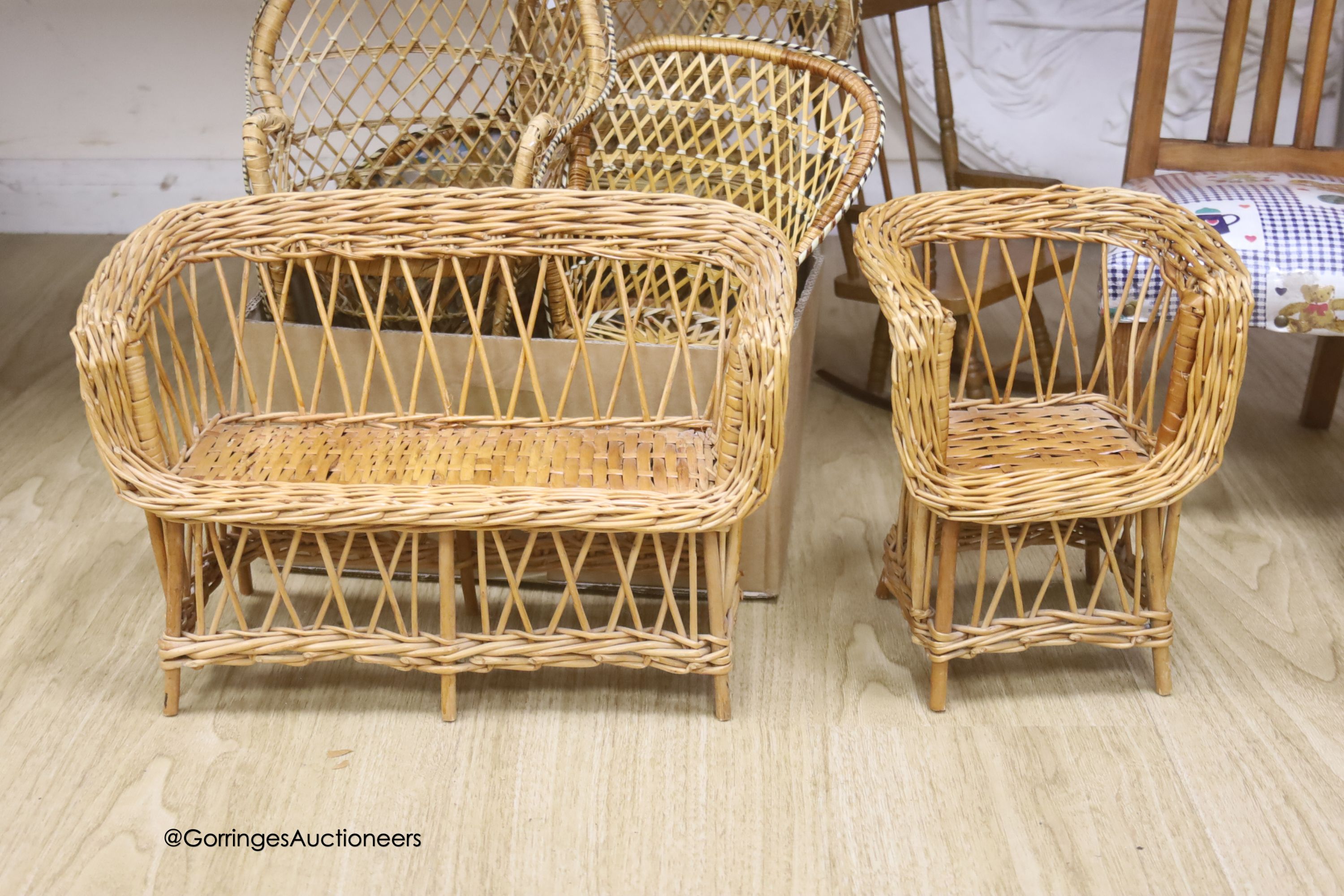 A wicker settle and six wicker chairs for display, together with a child's modern Windsor chair and two wooden chairs